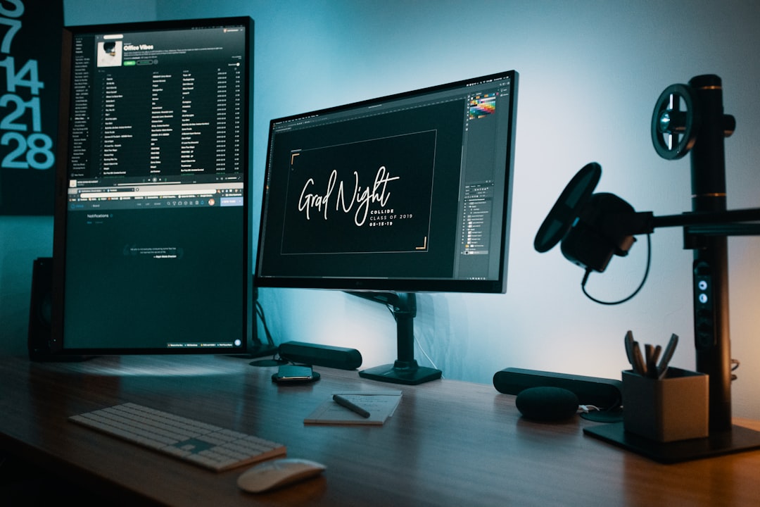 two-flat-screen-computer-monitors-on-table-3wxtbg-u1g
